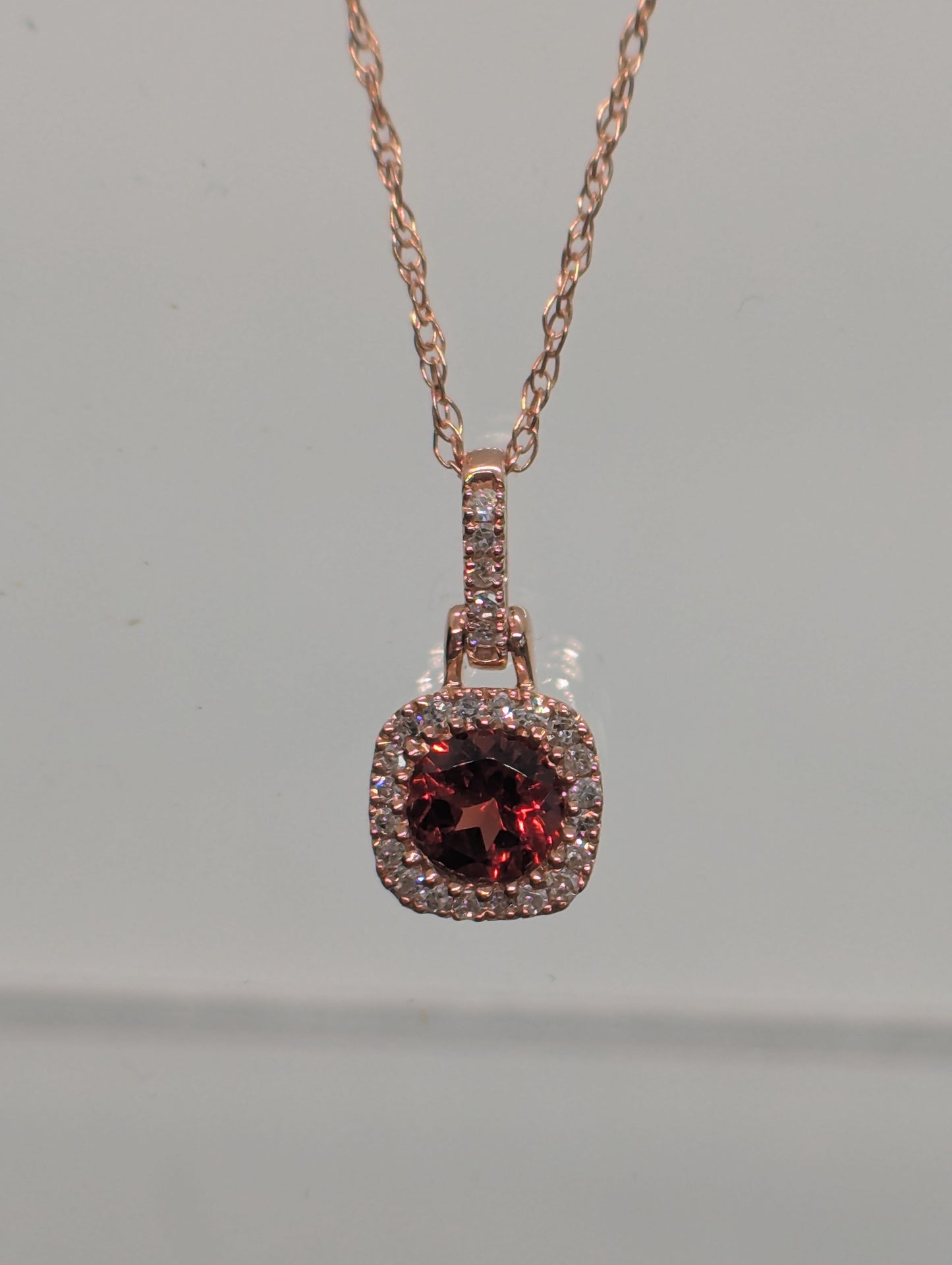 10K Rose Gold Garnet & 1/16CT. Natural Diamond Halo Pendant with Accented Bail