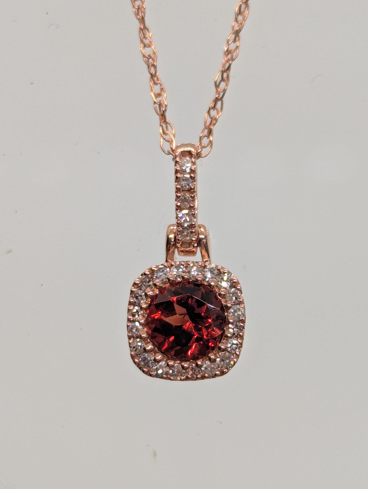 10K Rose Gold Garnet & 1/16CT. Natural Diamond Halo Pendant with Accented Bail